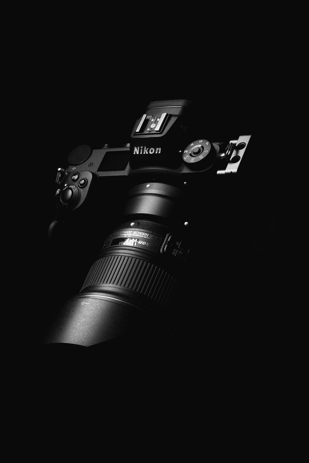 black nikon dslr camera on black surface