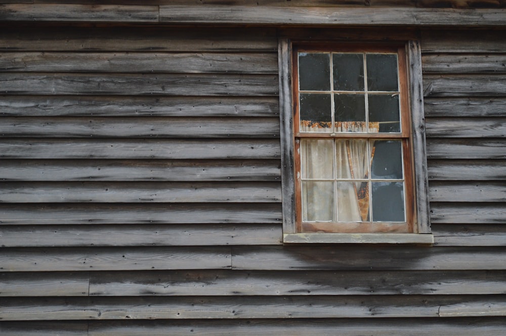 brown wooden window frame on gray wooden wall