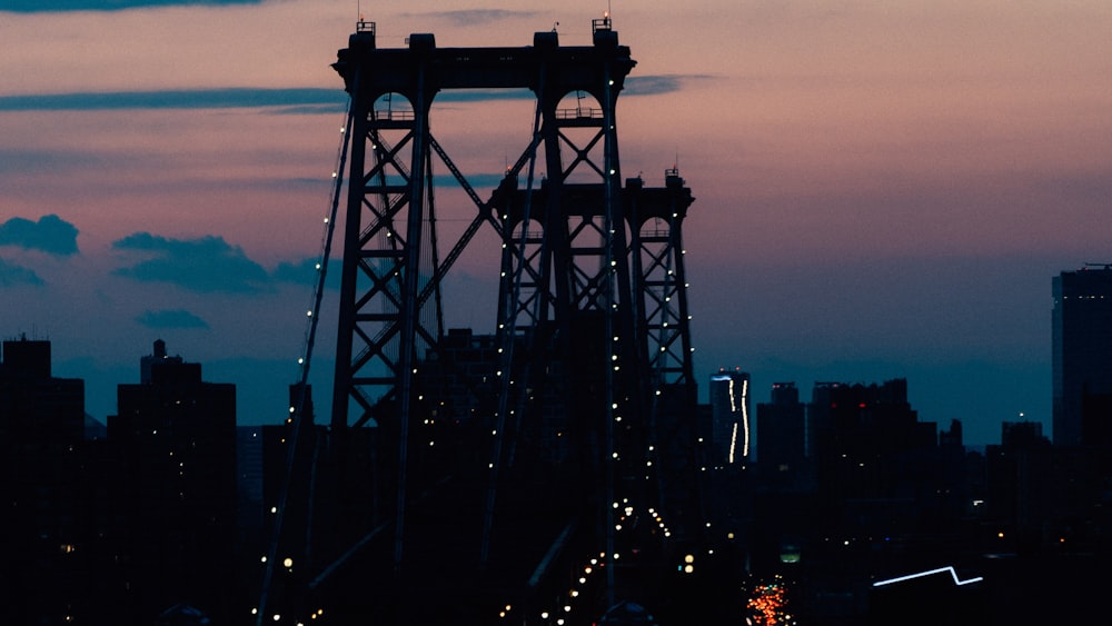 silhouette of people walking on bridge during night time