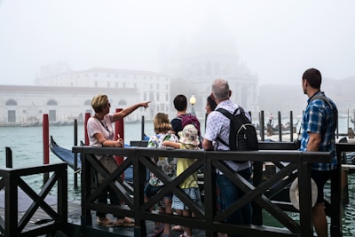 people standing on wooden dock during daytime