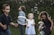 A group of children playing together in a vibrant outdoor garden space.