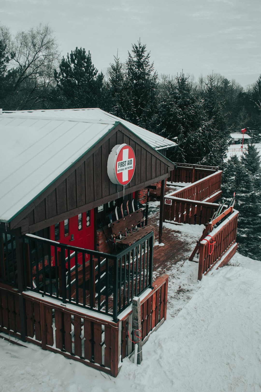 red wooden fence covered with snow