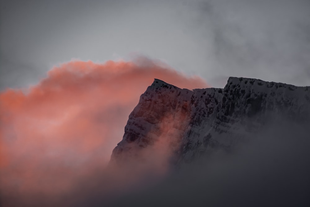 white and brown mountain under white clouds