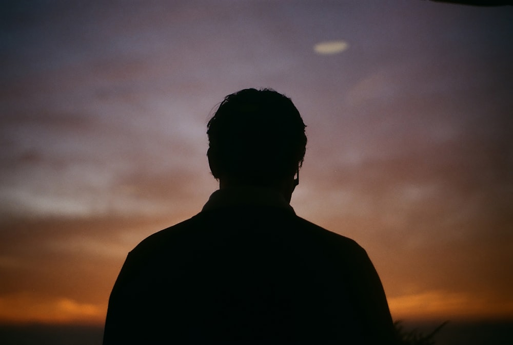 Silueta del hombre durante la puesta del sol