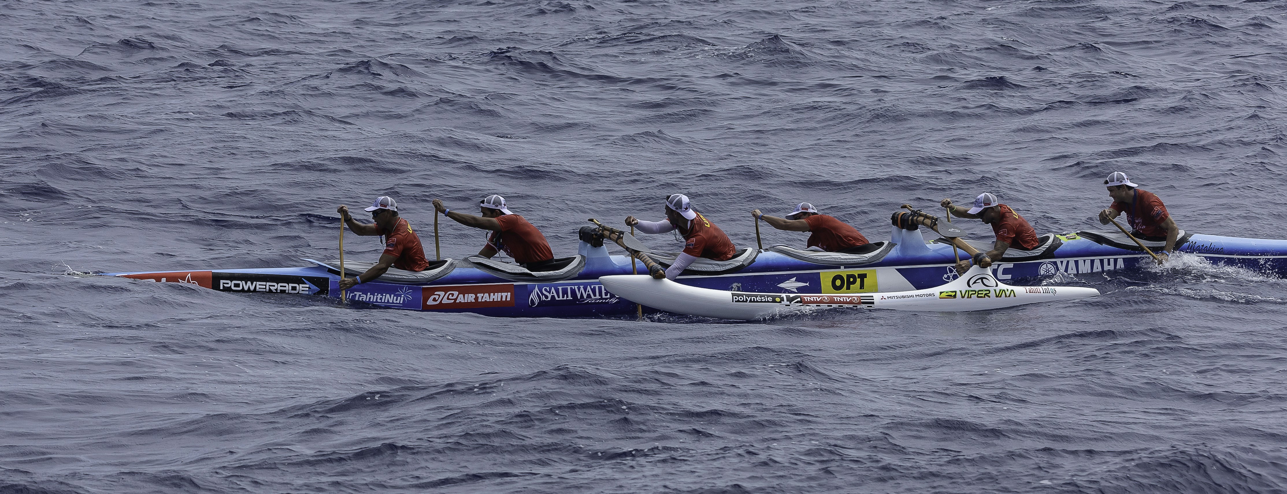 people riding blue kayak on sea during daytime