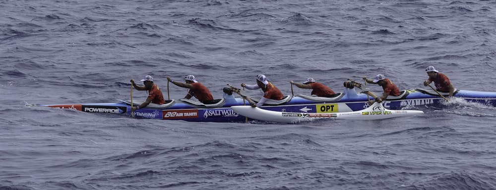 people riding blue kayak on sea during daytime