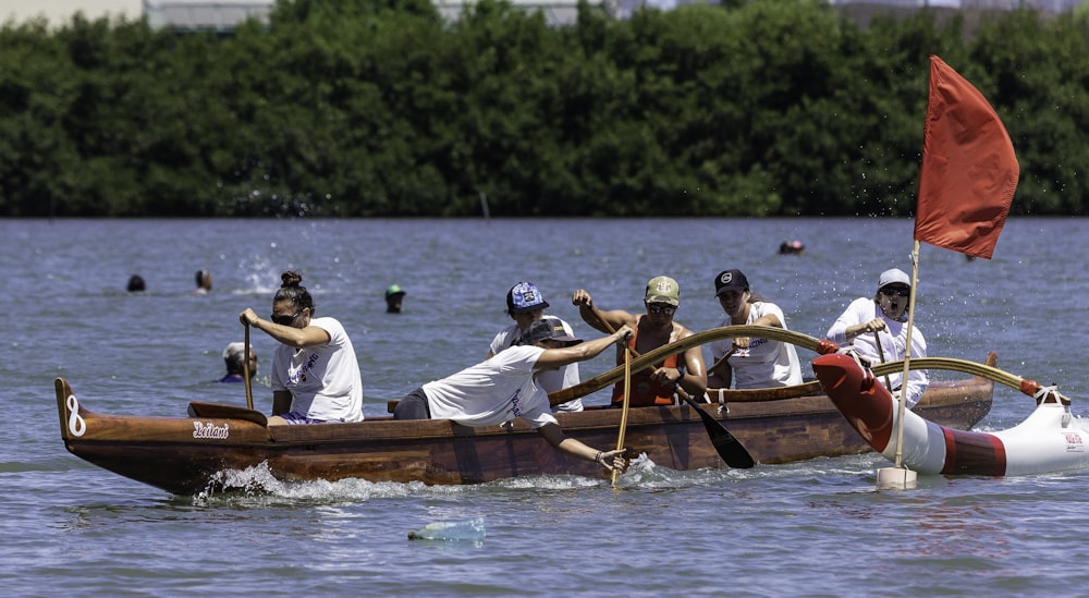 2 men riding on brown boat during daytime