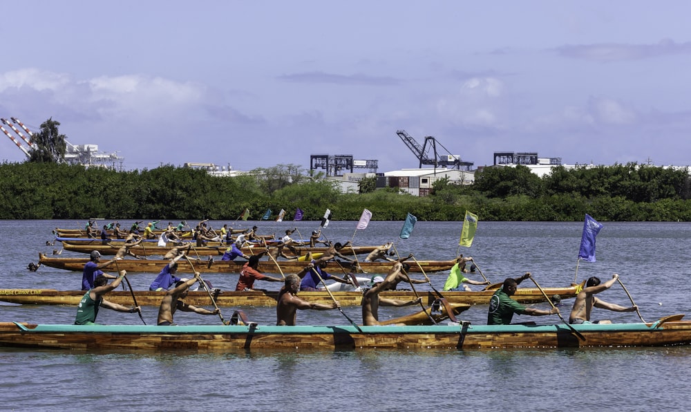 people riding on blue kayak boat during daytime