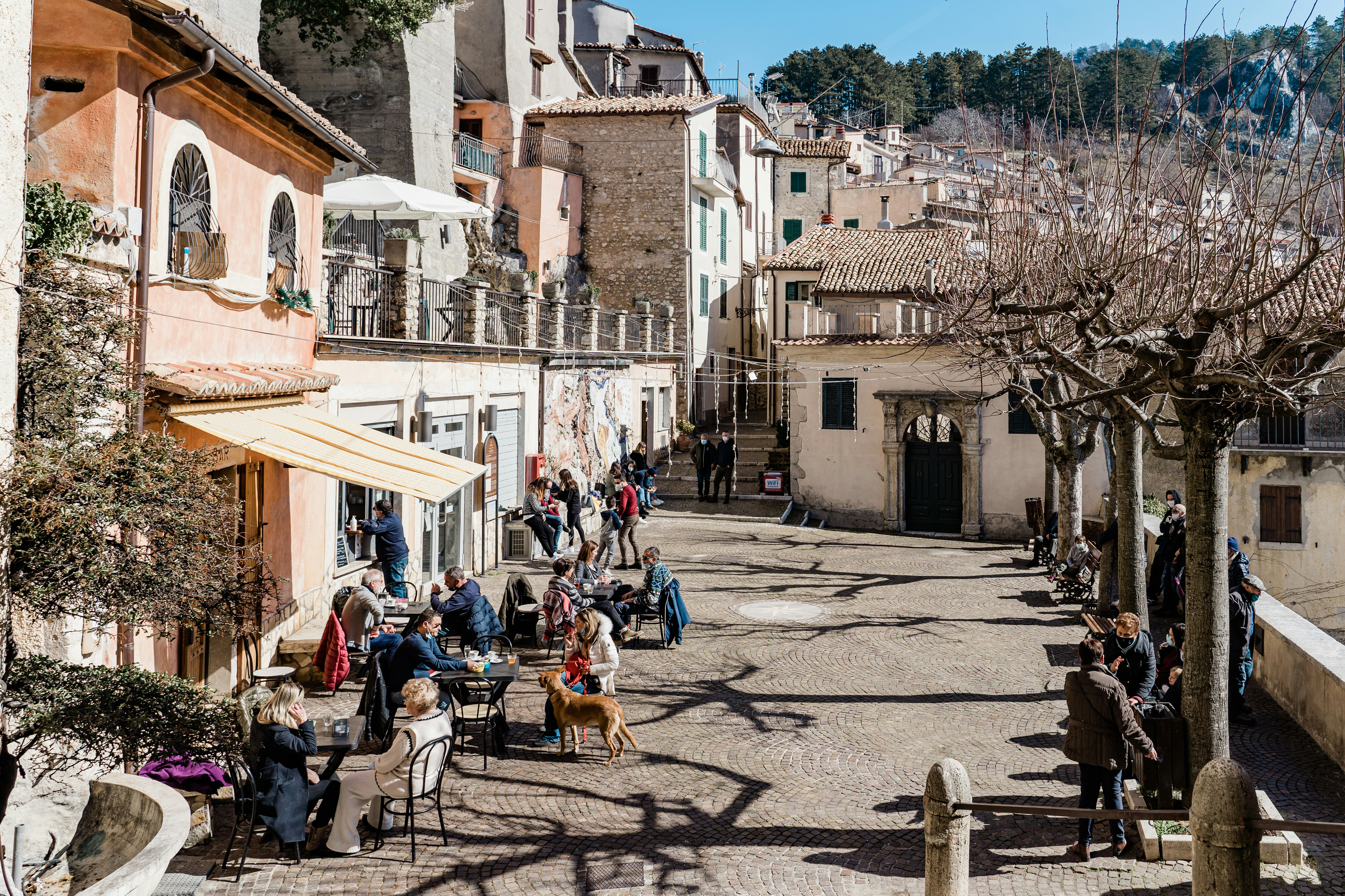 people sitting on chairs near brown concrete building during daytime