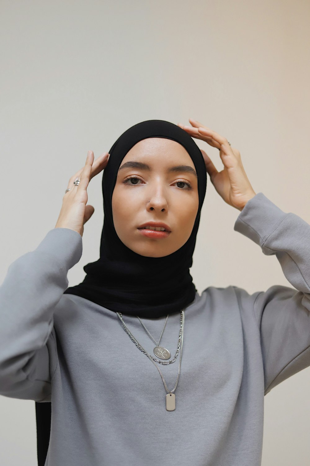 woman in gray long sleeved shirt wearing black hijab