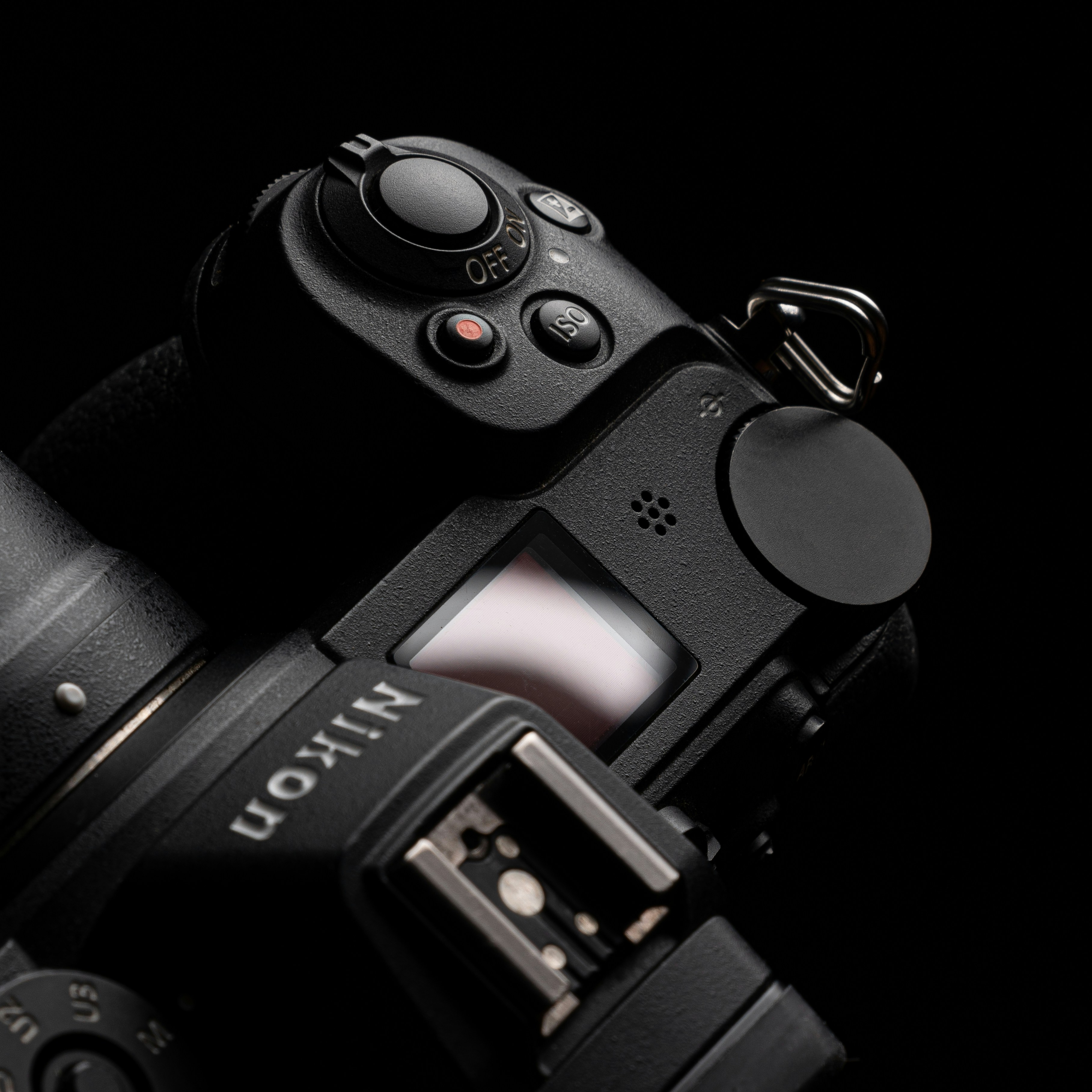 black nikon dslr camera on white surface