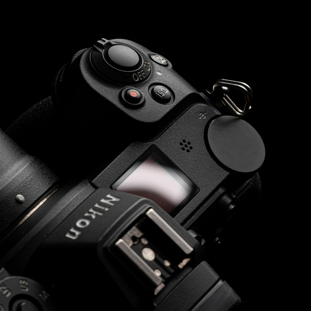 Appareil photo reflex numérique Nikon noir sur surface blanche