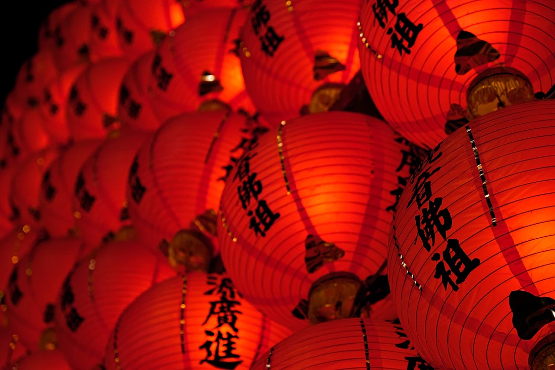 Red lanterns with Chinese characters glowing at night