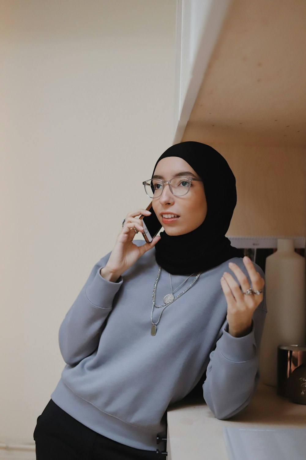 woman in gray hoodie wearing black hijab