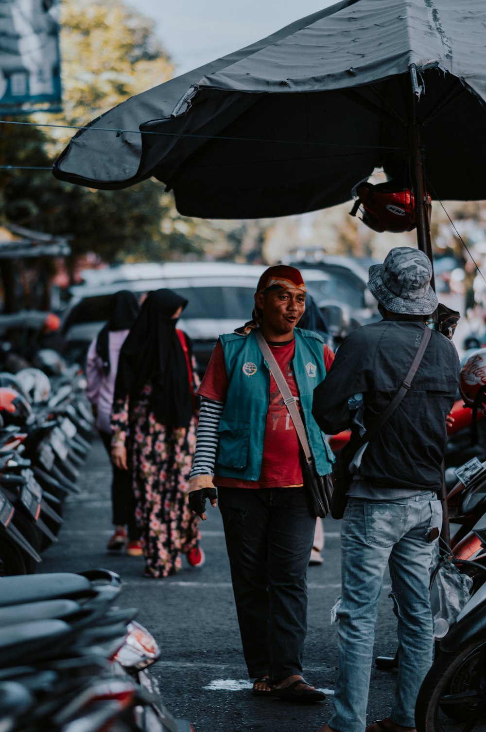 man in red jacket standing beside woman in black jacket