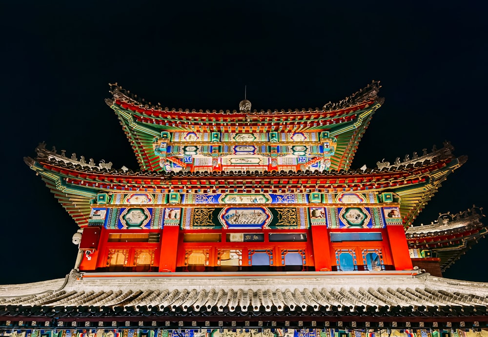 red and green chinese temple during night time