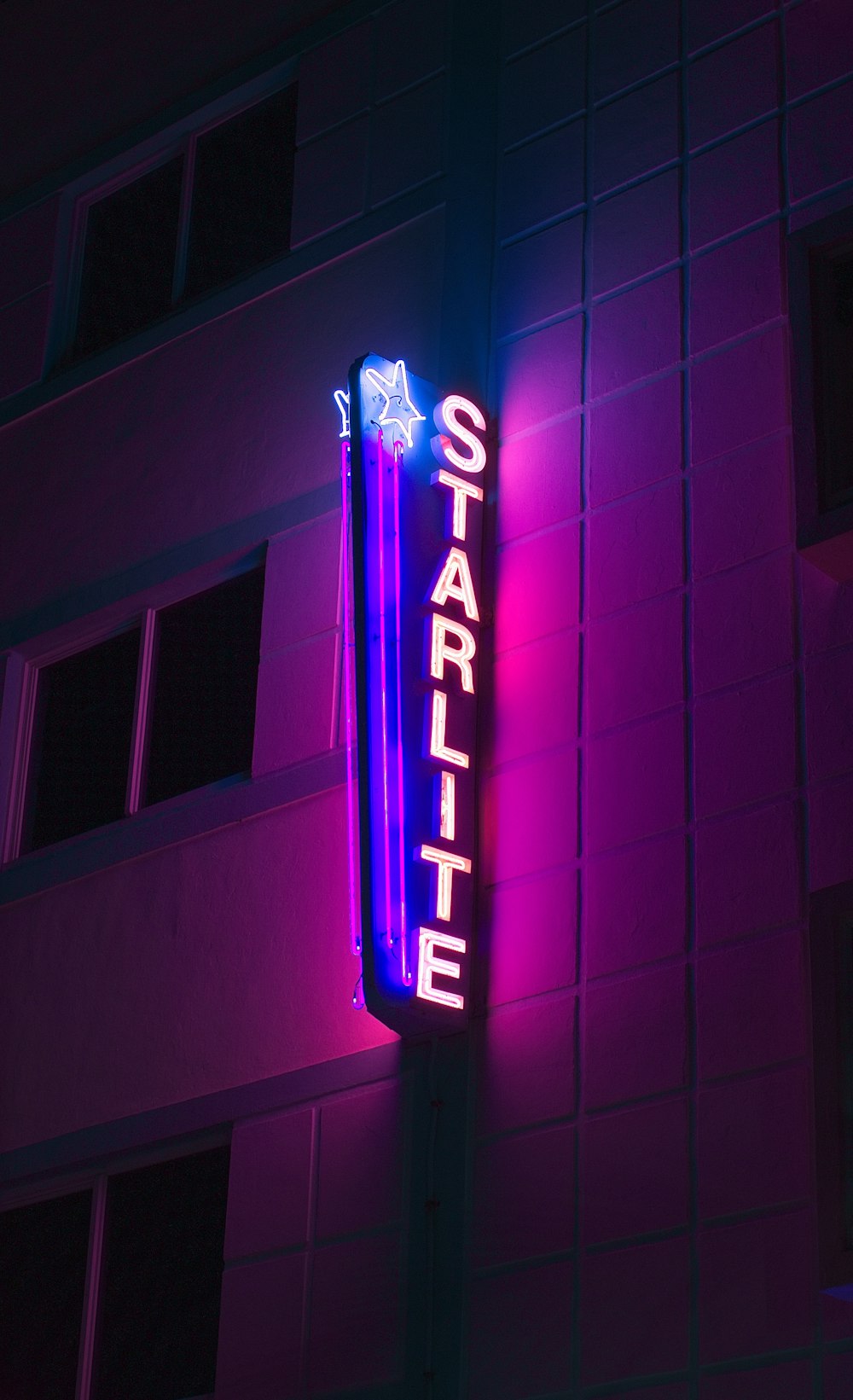 a neon sign on the side of a building