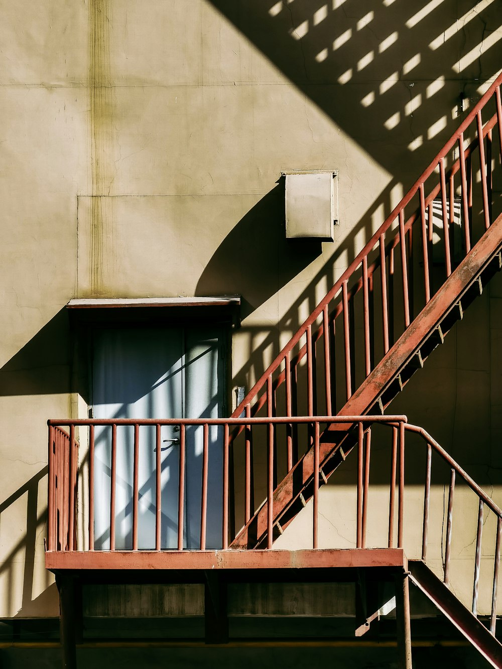 white concrete staircase with brown metal railings