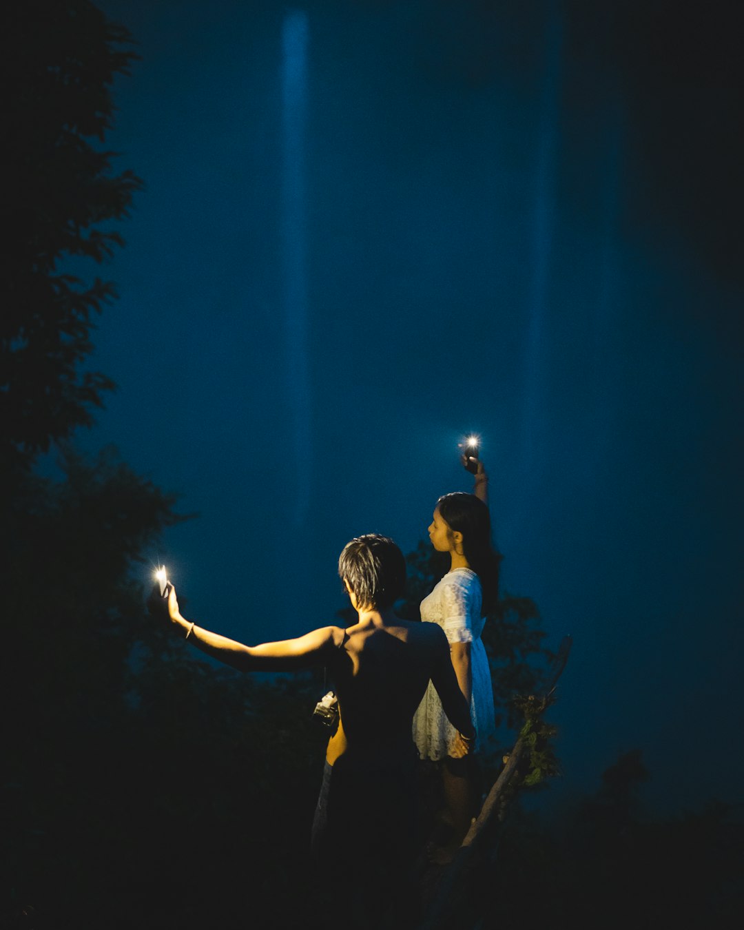 man and woman kissing during night time