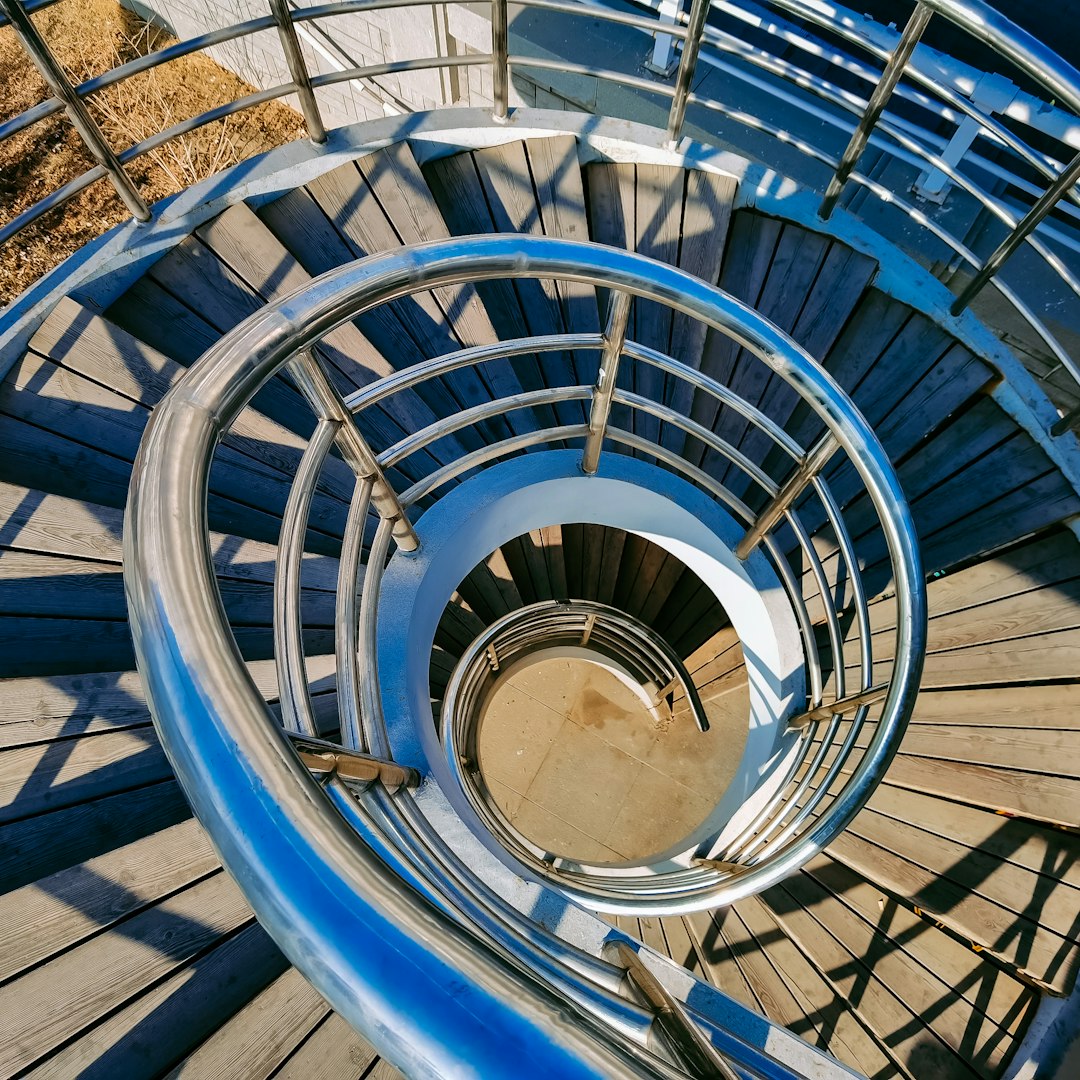 blue spiral staircase with blue railings