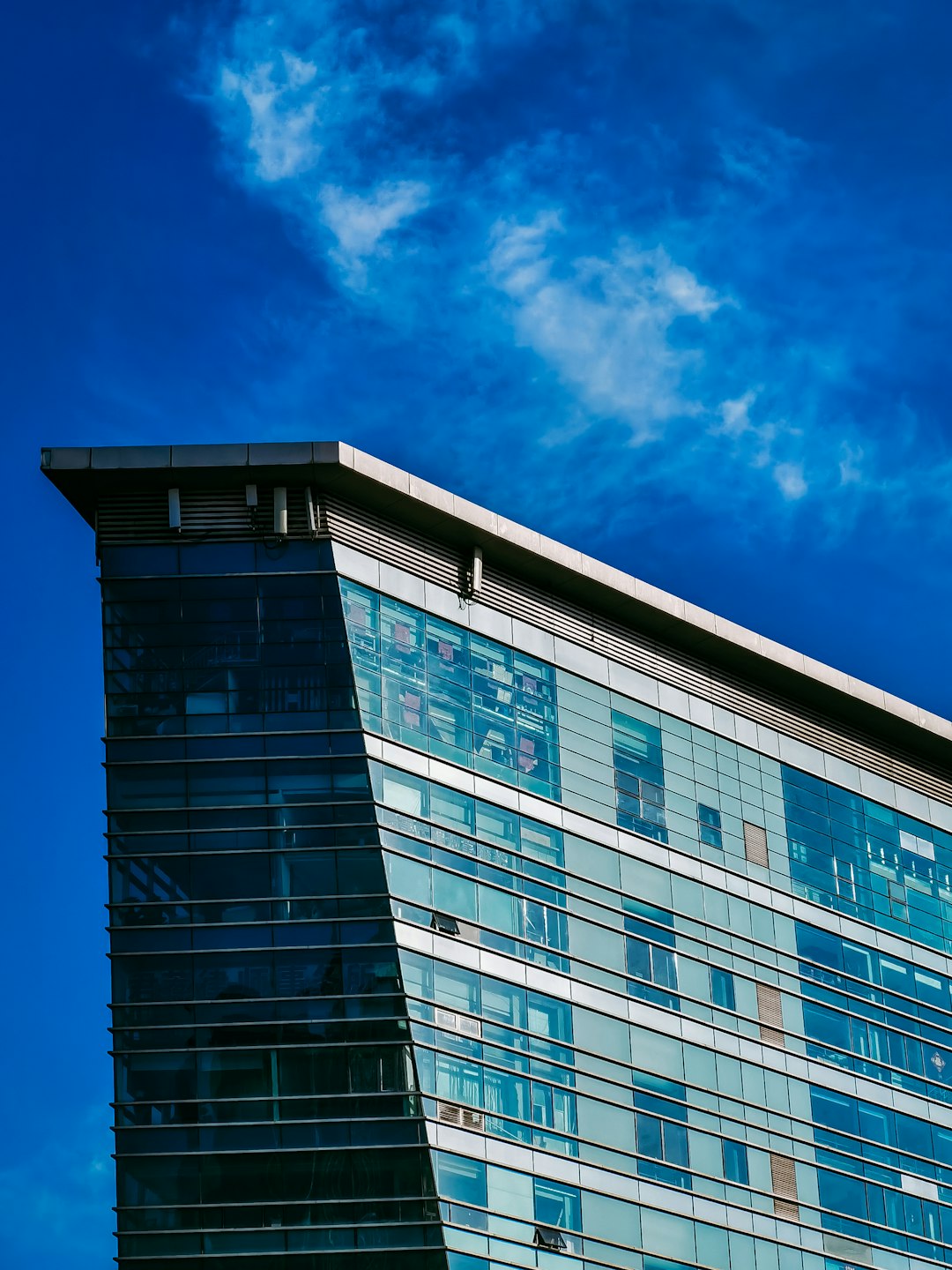 blue and white concrete building under blue sky during daytime