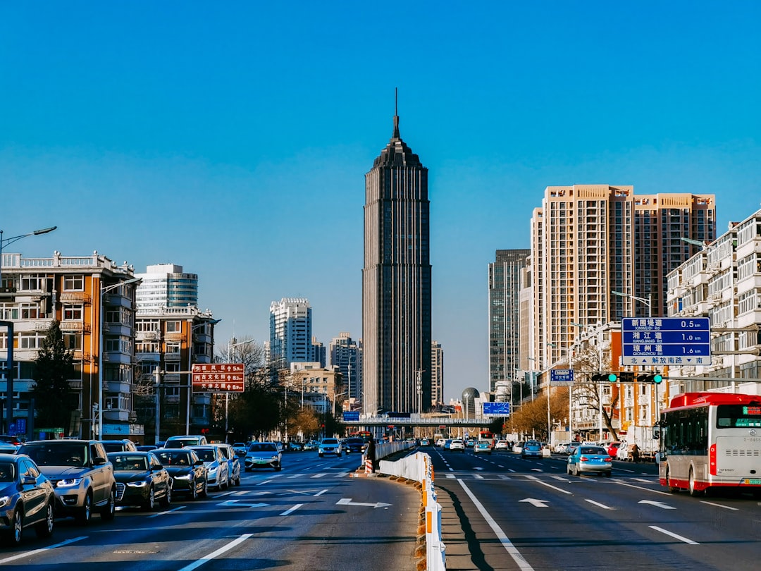 cars on road near high rise buildings during daytime