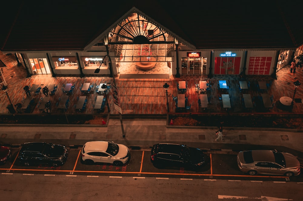 cars parked in front of building during night time