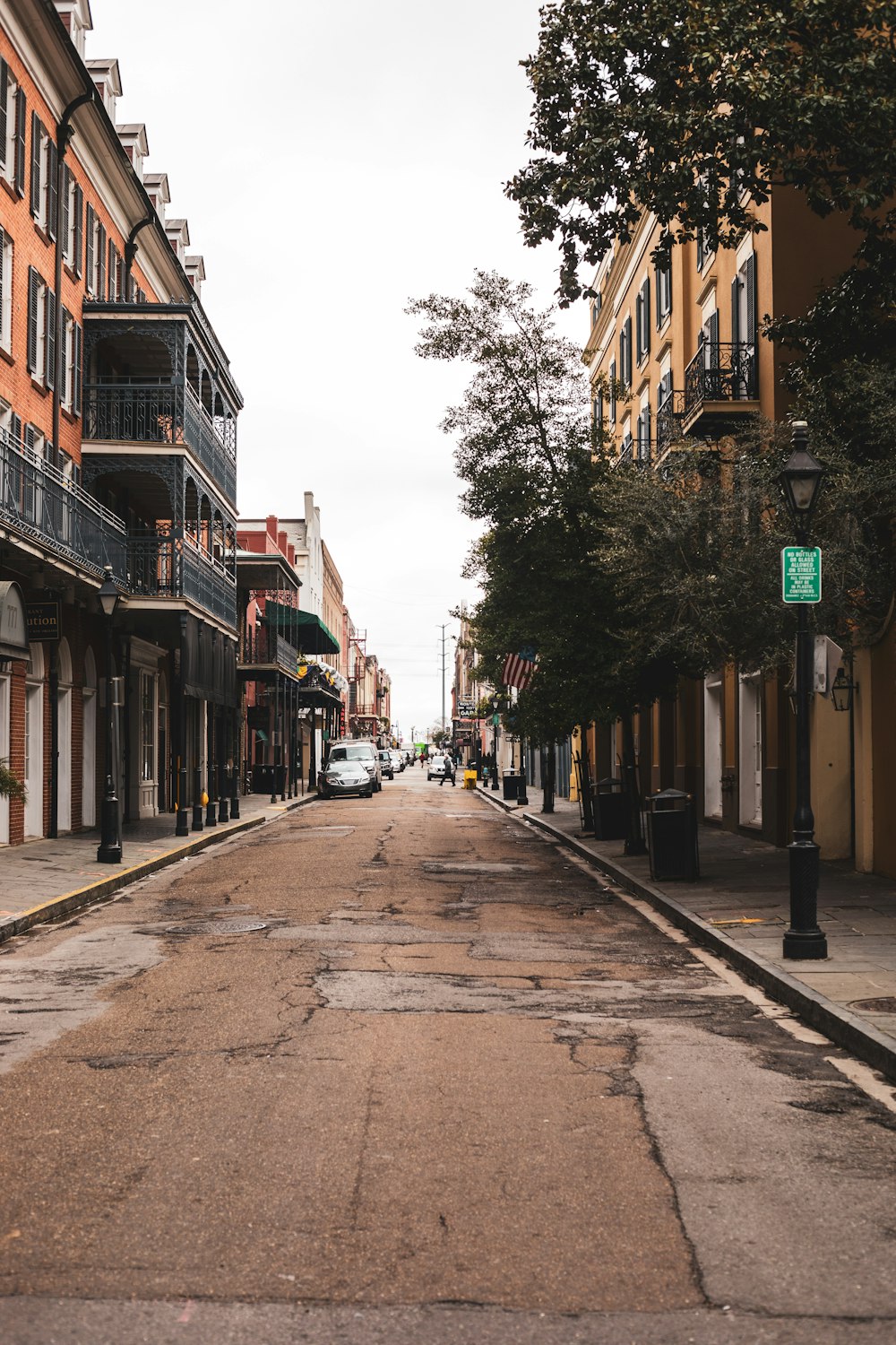 people walking on sidewalk between buildings during daytime