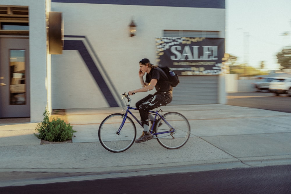 man in black t-shirt riding on black bicycle during daytime