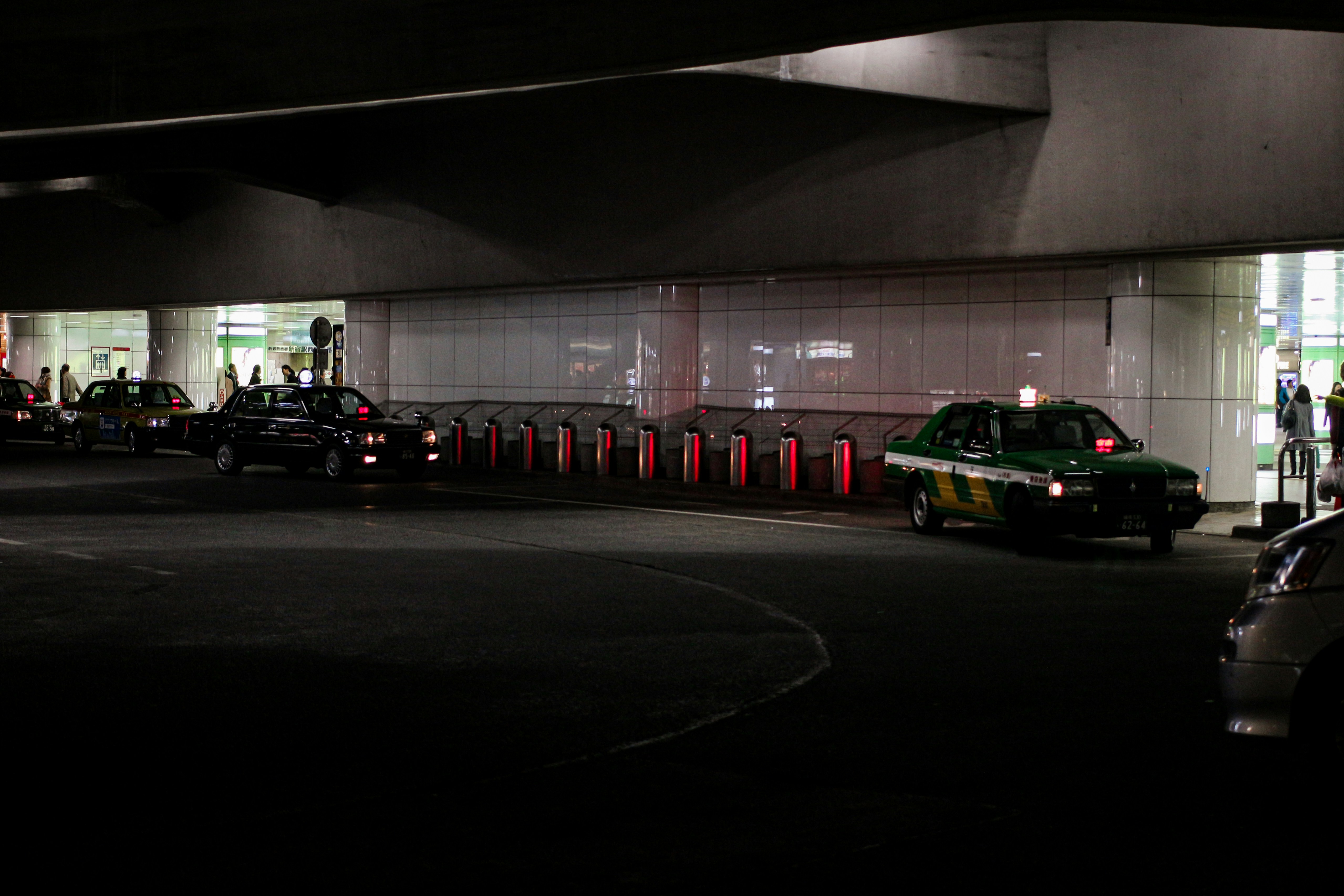 Several electric cars parked side by side at a modern US public charging station