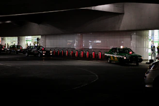 A busy taxi stand in Çamlıbel with cars lined up and passengers waiting under city lights.
