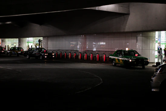 A busy taxi stand in Çamlıbel with cars lined up and passengers waiting under city lights.