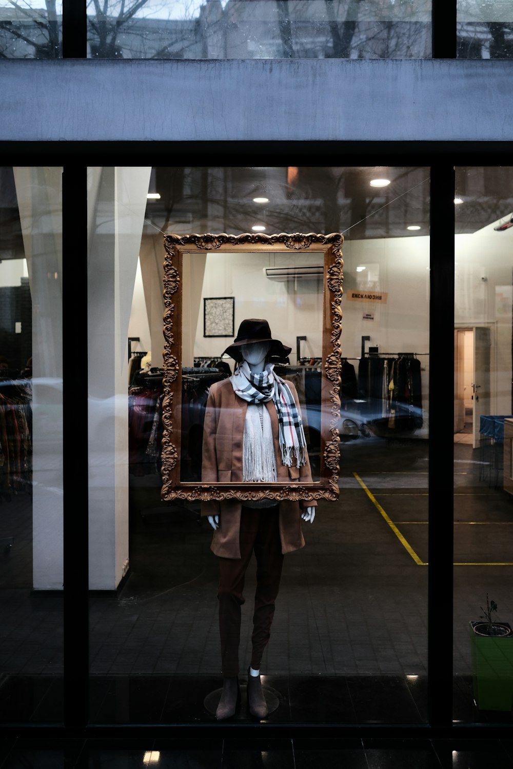 woman in black and white long sleeve shirt and black pants standing in front of mirror