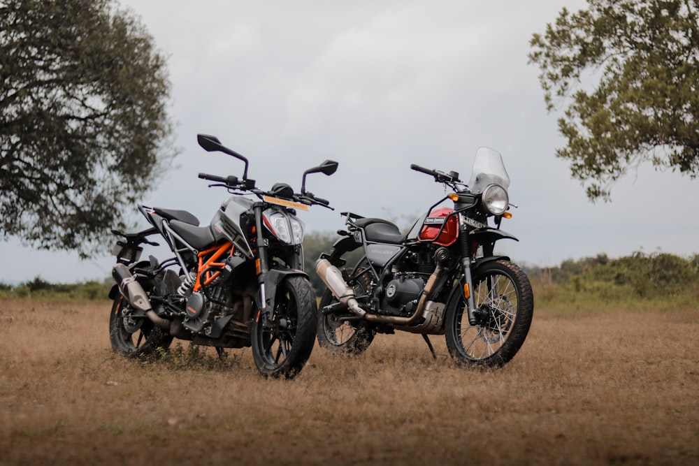 black and red naked motorcycle on brown field during daytime