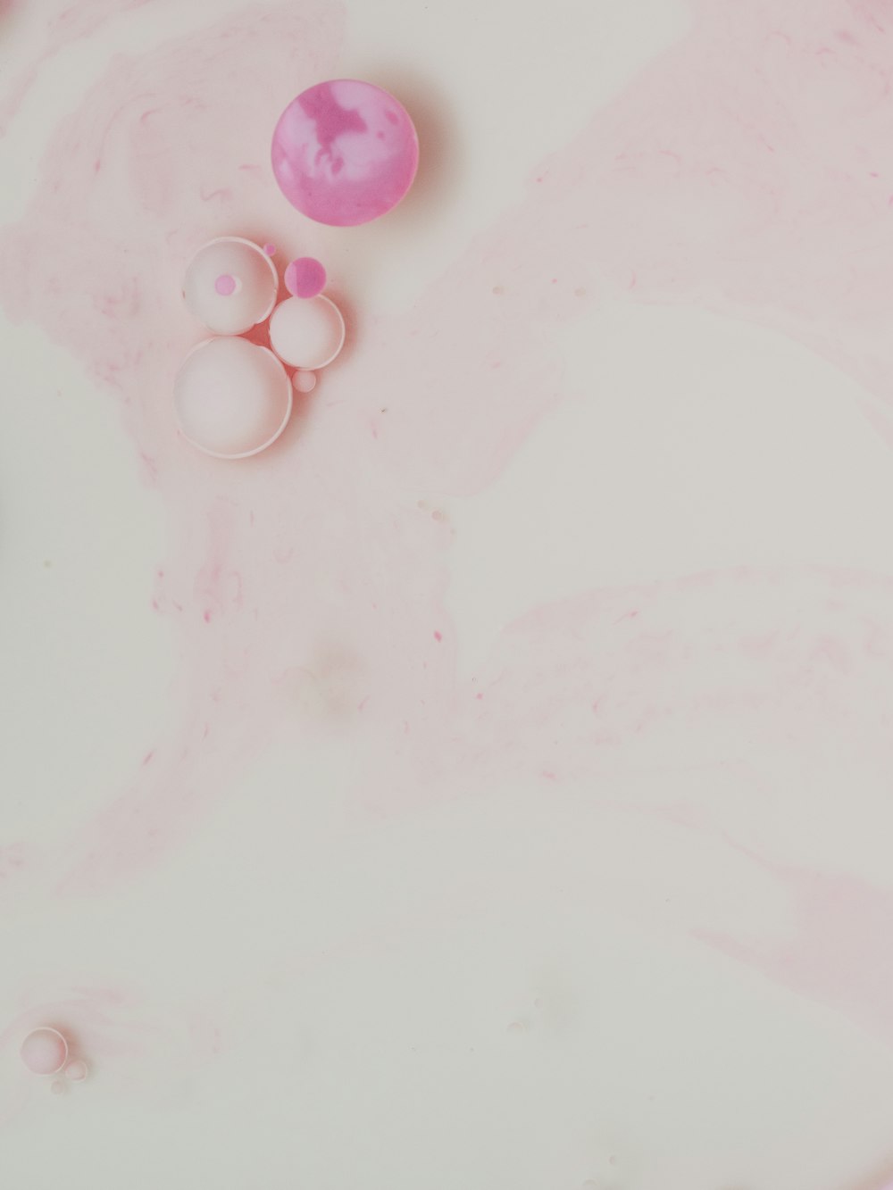pink round beads on white textile