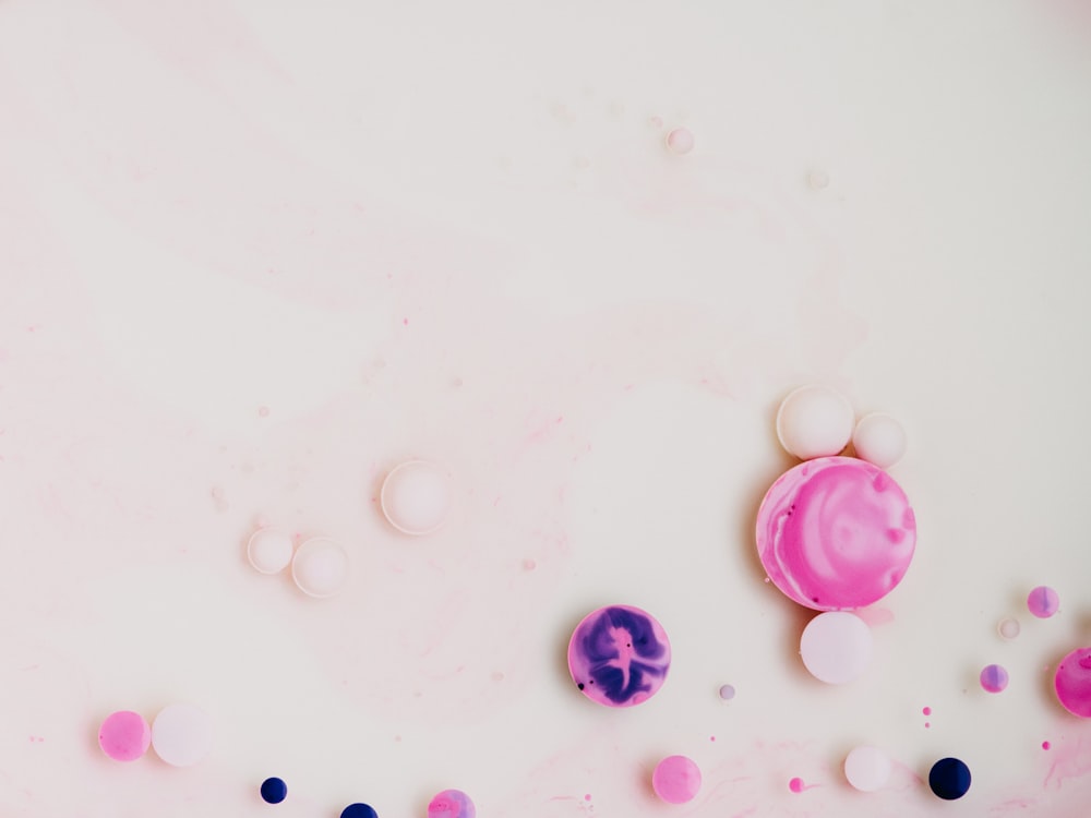 purple round plastic beads on white surface