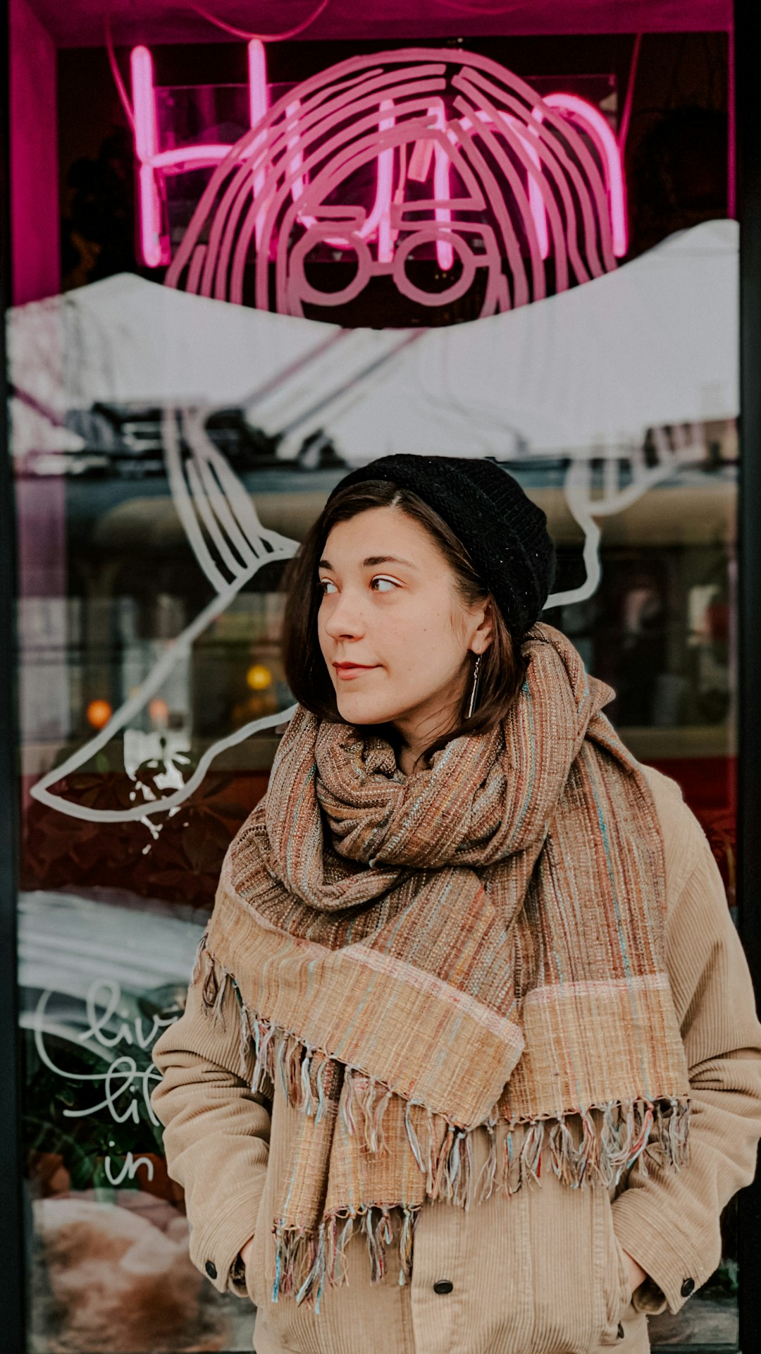 woman in brown and white plaid scarf and black knit cap