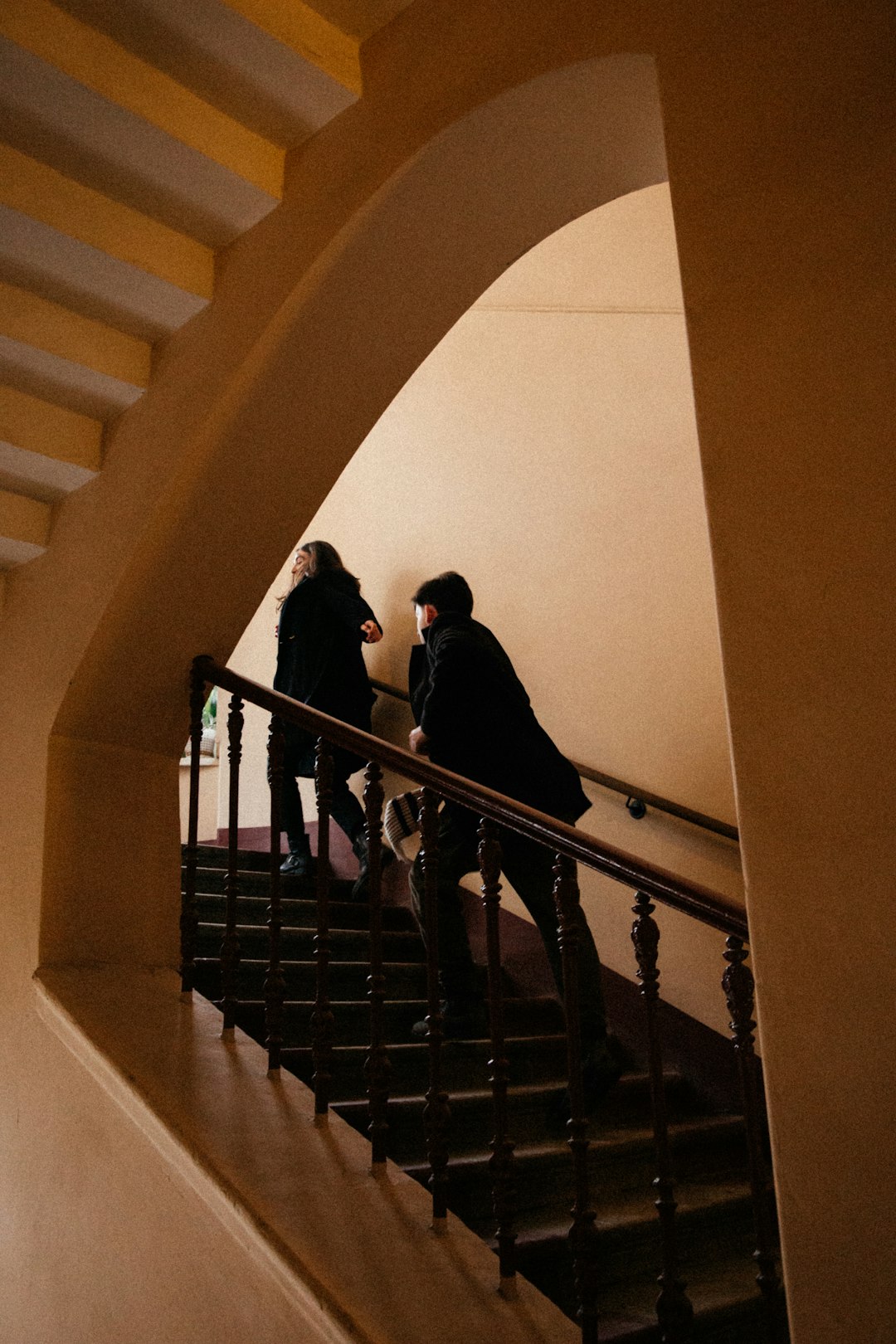man and woman walking on staircase