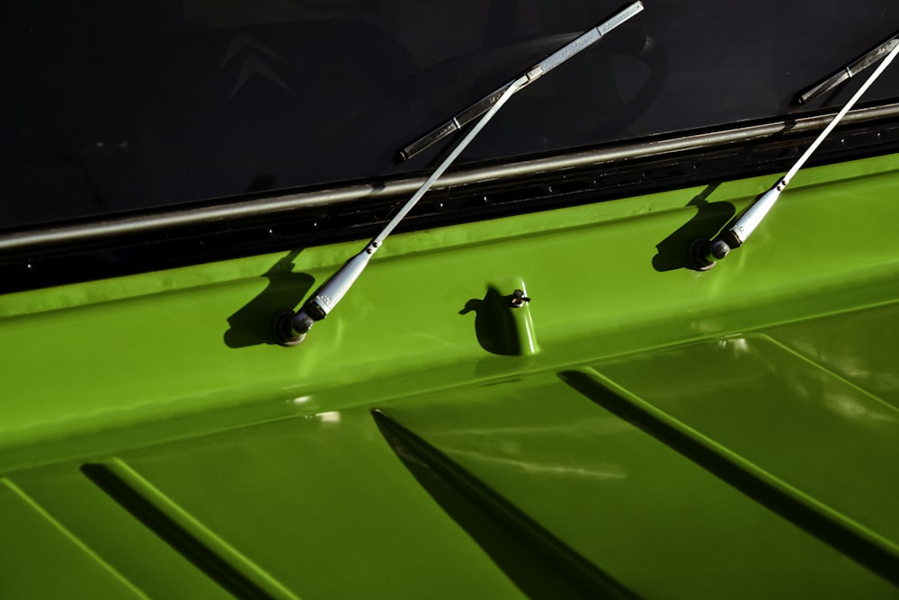 a close up of a green vehicle with metal handles