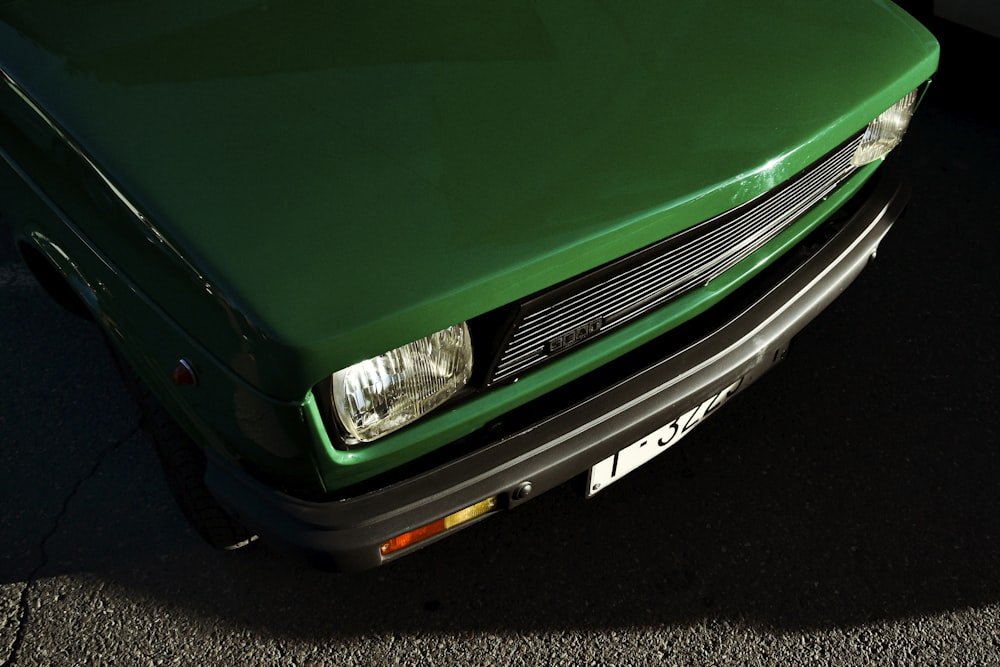 a green car parked on the side of the road