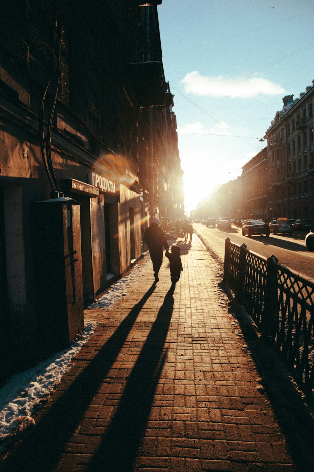 person walking on sidewalk during sunset