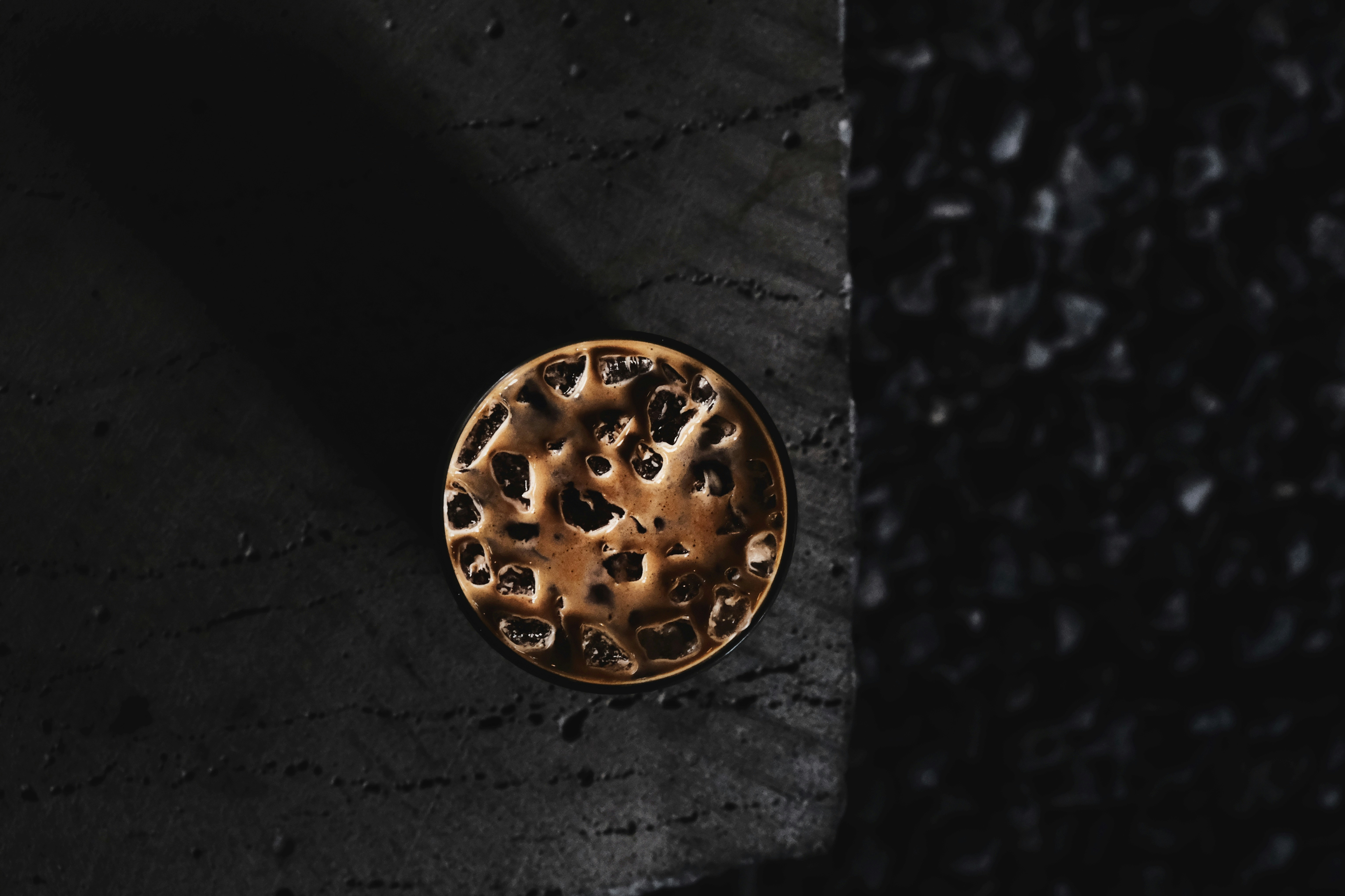 silver round ornament on black surface