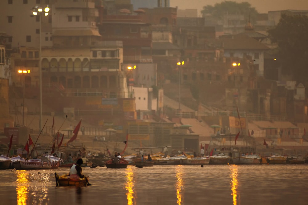 people on boat on water during sunset