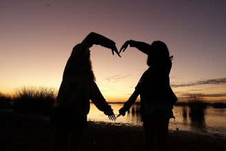 An artistic shot of a couple during a sunset.