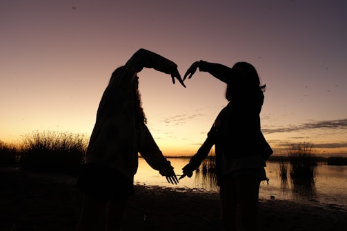 An artistic shot of a couple during a sunset.