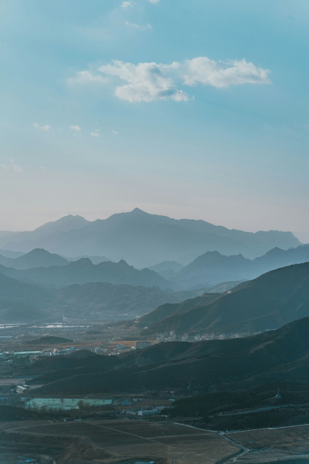 body of water near mountains during daytime