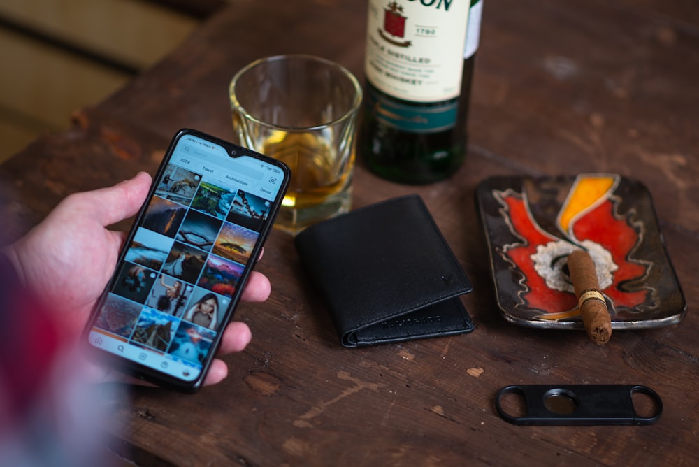 black iphone 5 on brown wooden table