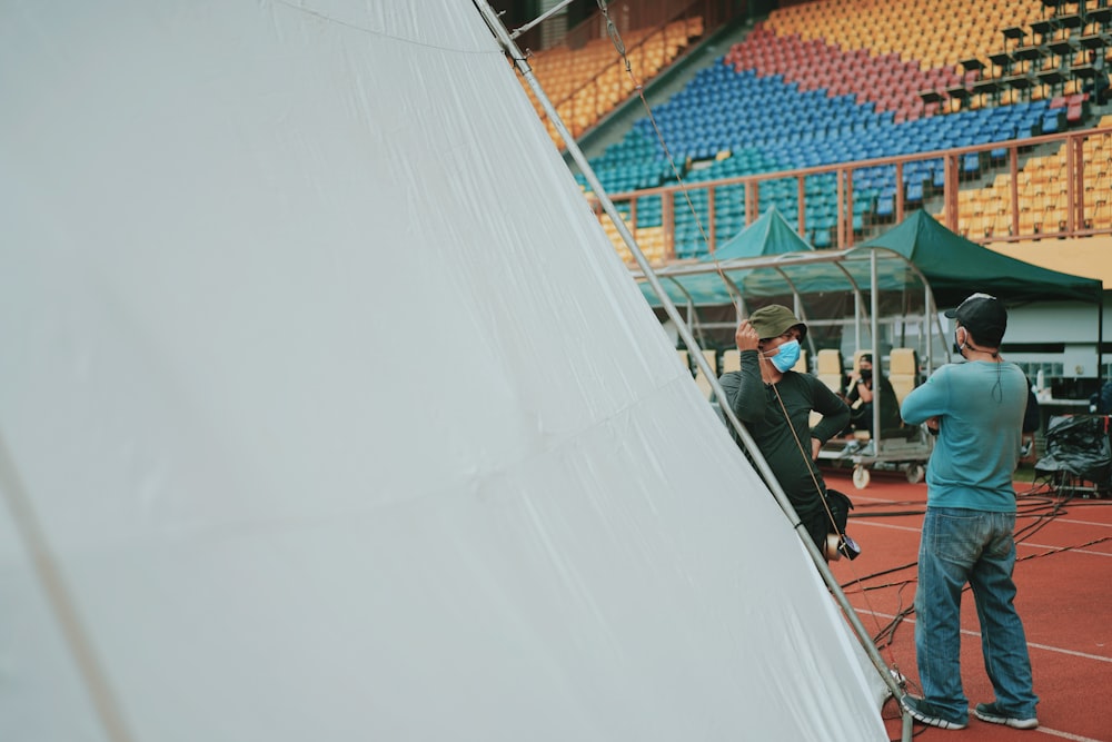 people sitting on red and white chairs during daytime