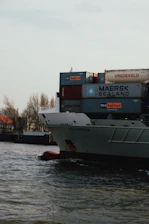 white and red cargo ship on dock during daytime