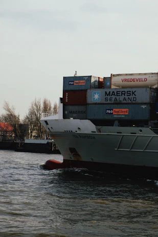 white and red cargo ship on dock during daytime